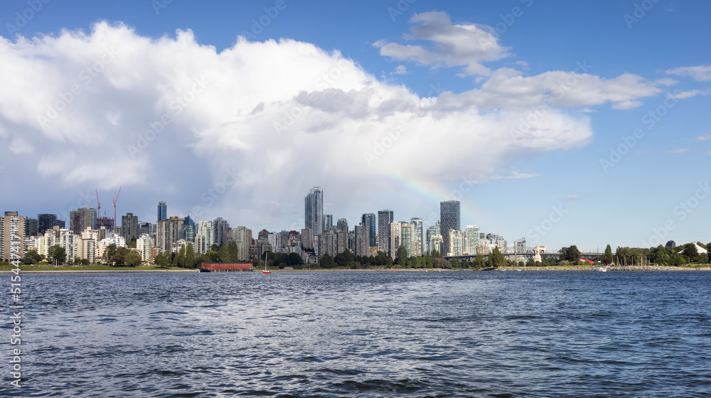 Downtown Vancouver City Skyline with clouds and rainbow. False Creek, British Columbia, Canada. Modern Cityscape on West Coast of Pacific Ocean.