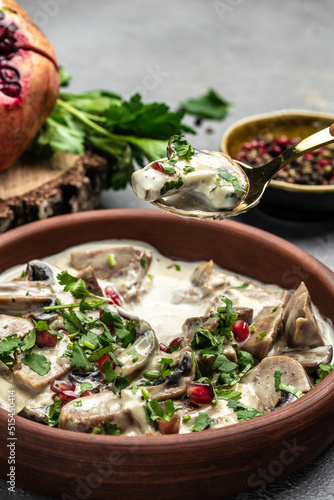 Slow cooked pork stew with mushrooms in creamy sauce served with parsley. Restaurant menu, dieting, cookbook recipe top view