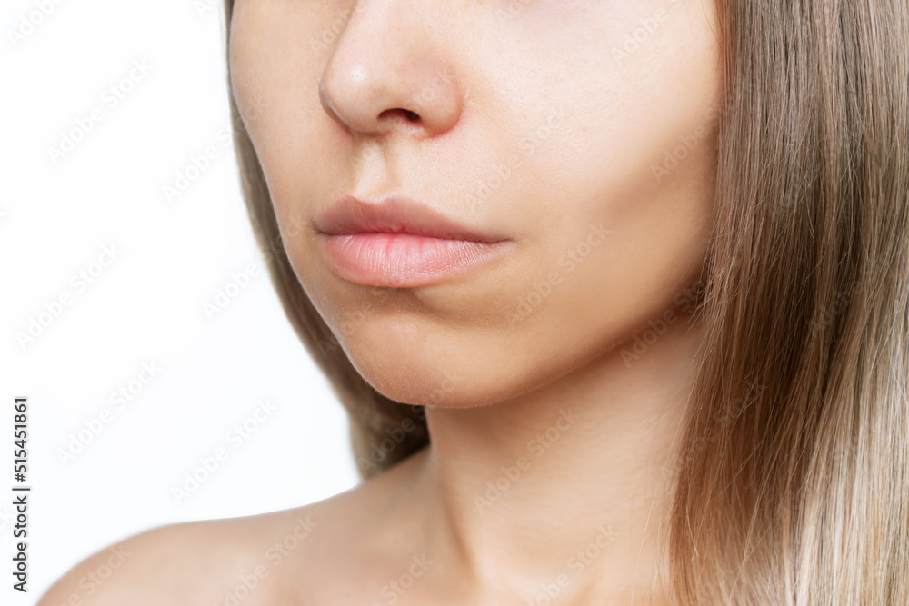 Cropped shot of a young caucasian woman's lower part of the face with clear highlighted cheekbones isolated on a white background. Plastic surgery buccal fat removal. Result of cosmetic surgery