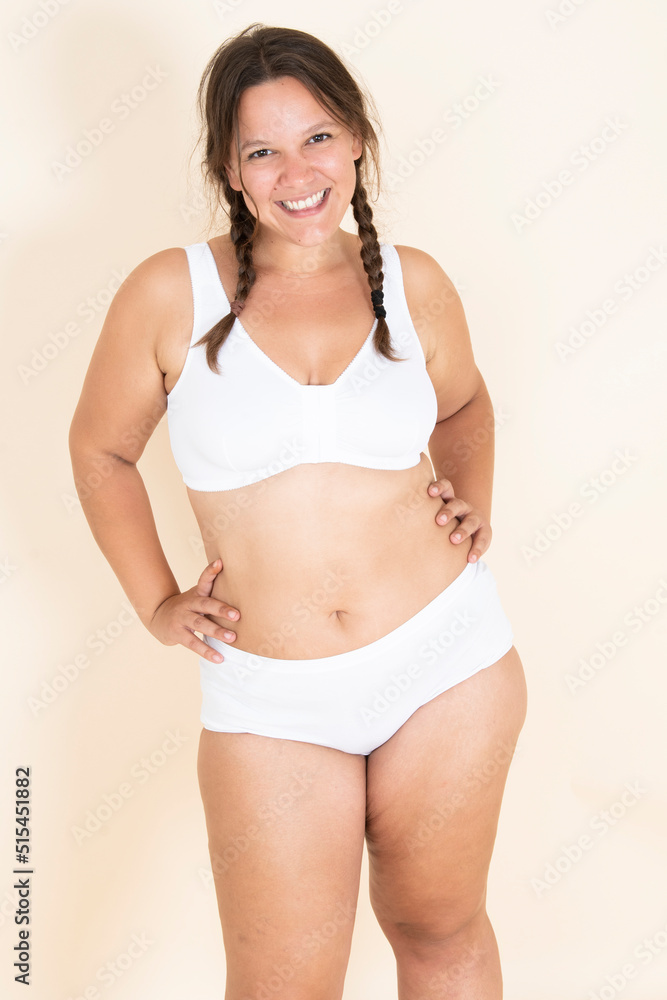 Plus size girl in lingerie with two braids smiling and showing off her body. proud of her body Plus size girl in lingerie with two braids smiling and showing off her body. proud of her body
