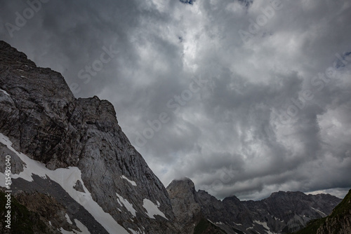 Mountain hiking Trail Road. Grey sky before thunderstorm. Between Italy and Austria: near Volaia Lake Raunchkofer Mountain (Lago di Volaia Monte Rauchkofel)