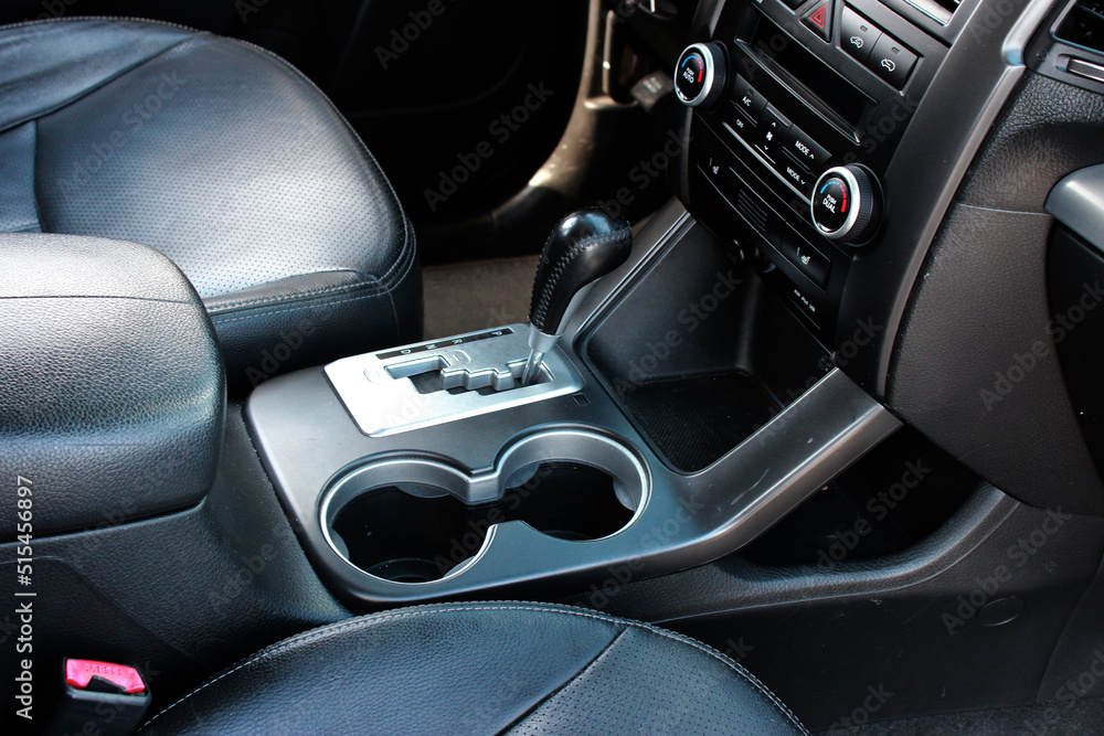 Close up of the automatic gearbox lever SUV, black interior car. Off road Automatic transmission gearshift stick, Closeup a manual shift of modern car gear shifter, off road suv automatic gearbox Close up of the automatic gearbox lever SUV, black interior car. Off road Automatic transmission gearshift stick, Closeup a manual shift of modern car gear shifter, off road suv automatic gearbox