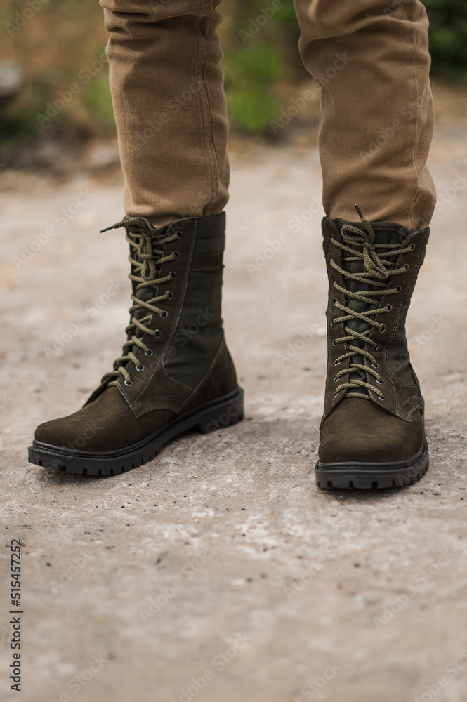 Military man in dark green leather tactical boots