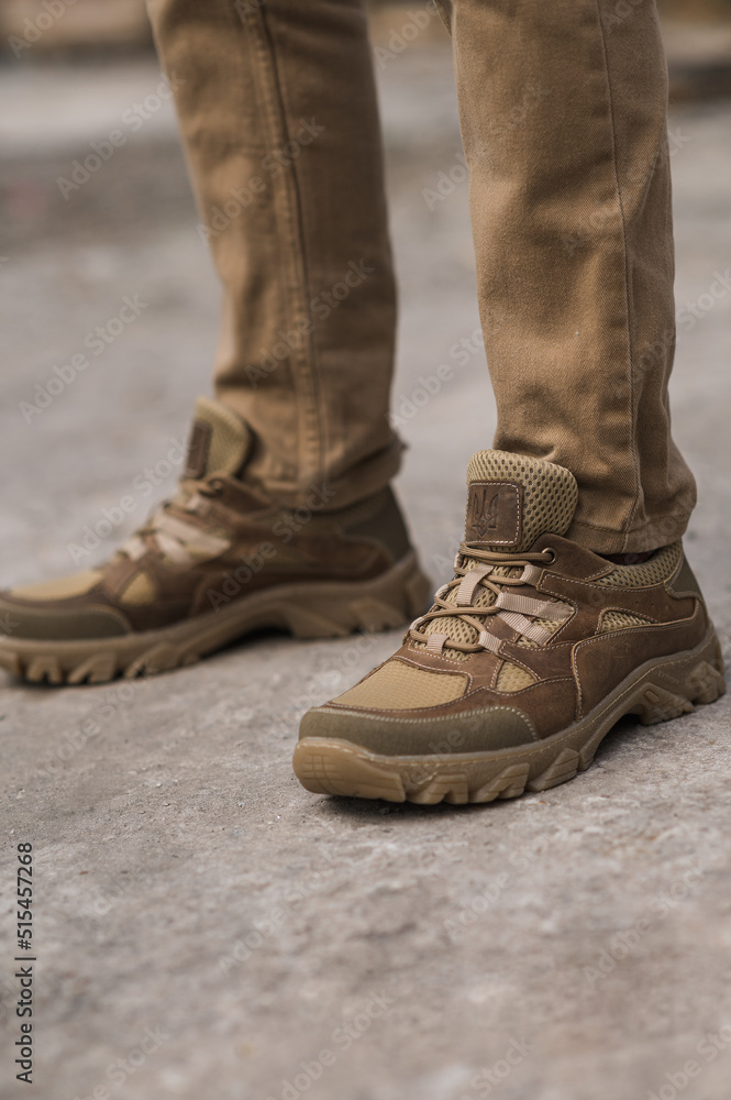 Military man in beige leather tactical sneakers Military man in beige leather tactical sneakers