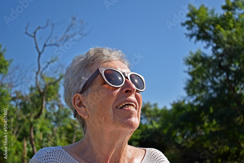 Elderly woman looking towards the sun