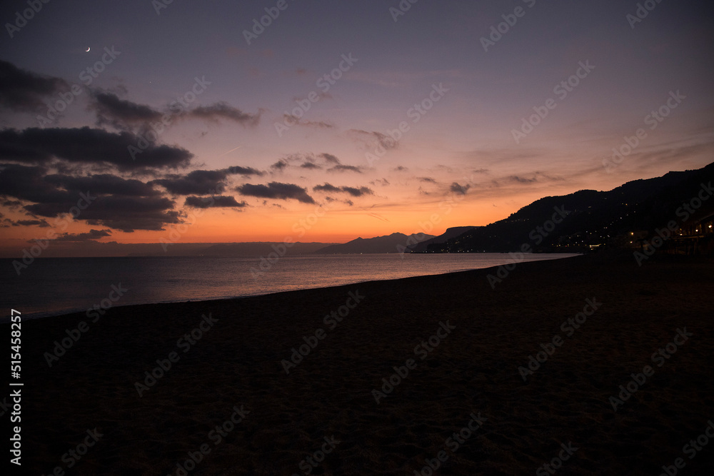 Sunset on the sea.
Seascape at sunset, with beach and distant lights of some countries. Sunset on the sea.
Seascape at sunset, with beach and distant lights of some countries.