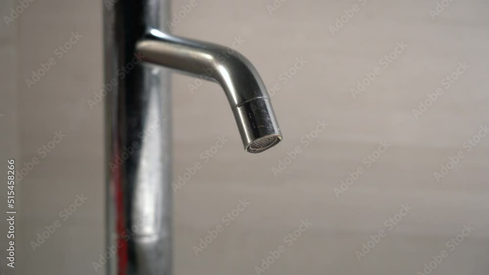 faucet leaks precious drops of water repeatedly waste of drinking water in homes in times of drought and aridity problem - incorrect use of natural resources by man faucet leaks precious drops of water repeatedly waste of drinking water in homes in times of drought and aridity problem - incorrect use of natural resources by man