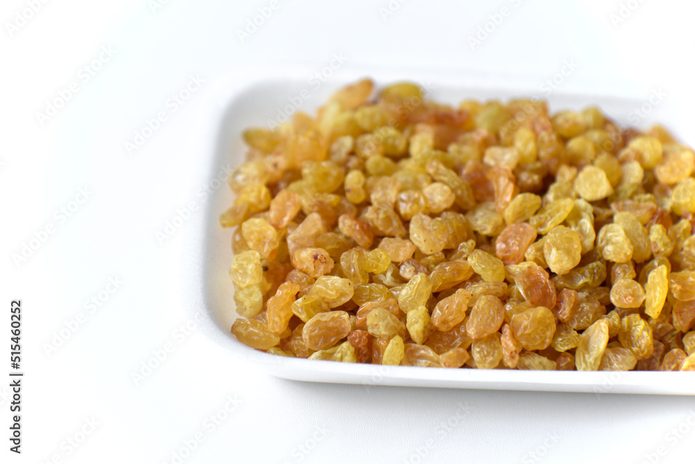 Juicy yellow raisins on a white backing Juicy yellow raisins on a white backing