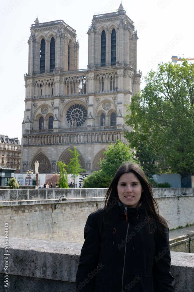 Young tourist girl at the Notre Dome Cathedral in Paris