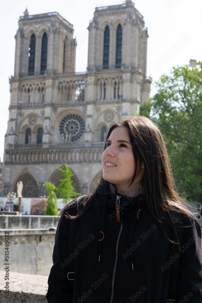 Young tourist girl at the Notre Dome Cathedral in Paris
