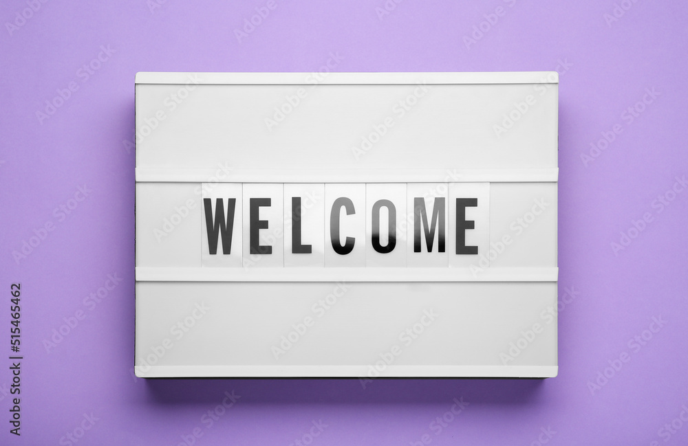 Lightbox with word Welcome on violet background, top view Lightbox with word Welcome on violet background, top view