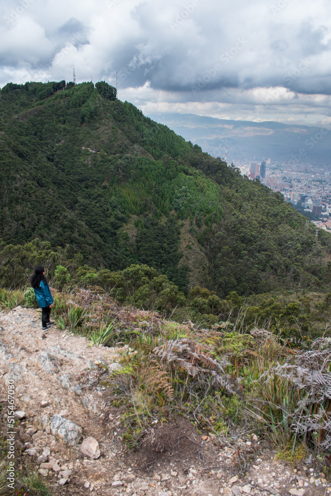 Young woman walking on Bogota  mountain path 	