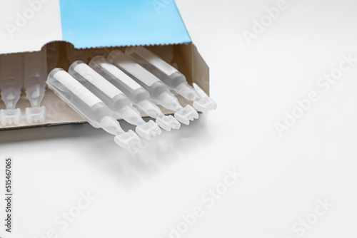 Package with single dose ampoules of sterile isotonic sea water solution on white background. Space for text photo