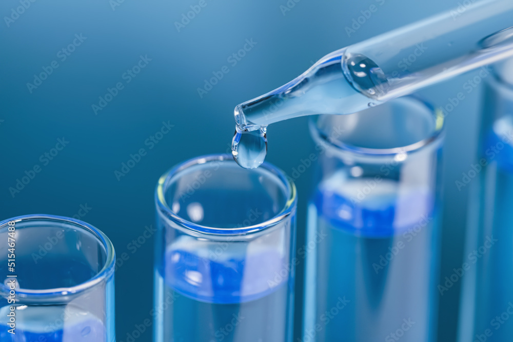 Dripping reagent into test tube on light blue background, closeup. Laboratory analysis Dripping reagent into test tube on light blue background, closeup. Laboratory analysis