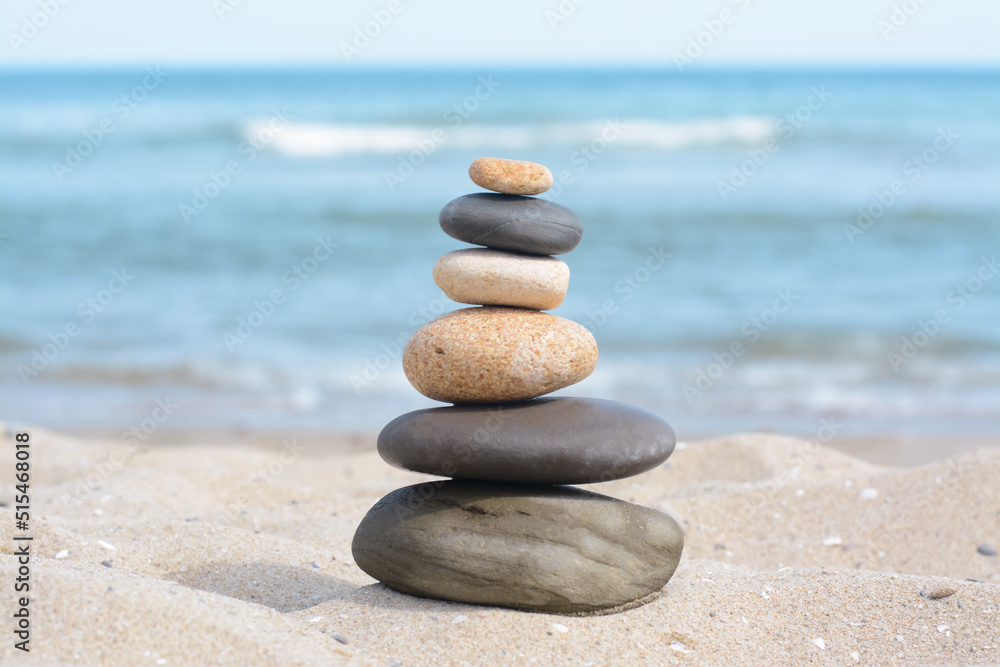 Stack of stones on sandy beach near sea Stack of stones on sandy beach near sea