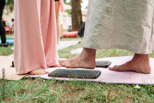 Alternative medicine and mindfulness practice - standing on sadhu board nails barefoot
