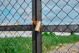 Brass padlock was locked with wire mesh door fence
