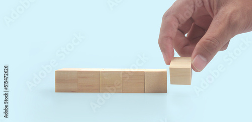 Wooden blocks in hand space and word decide