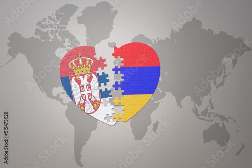 puzzle heart with the national flag of armenia and serbia on a world map background.Concept.