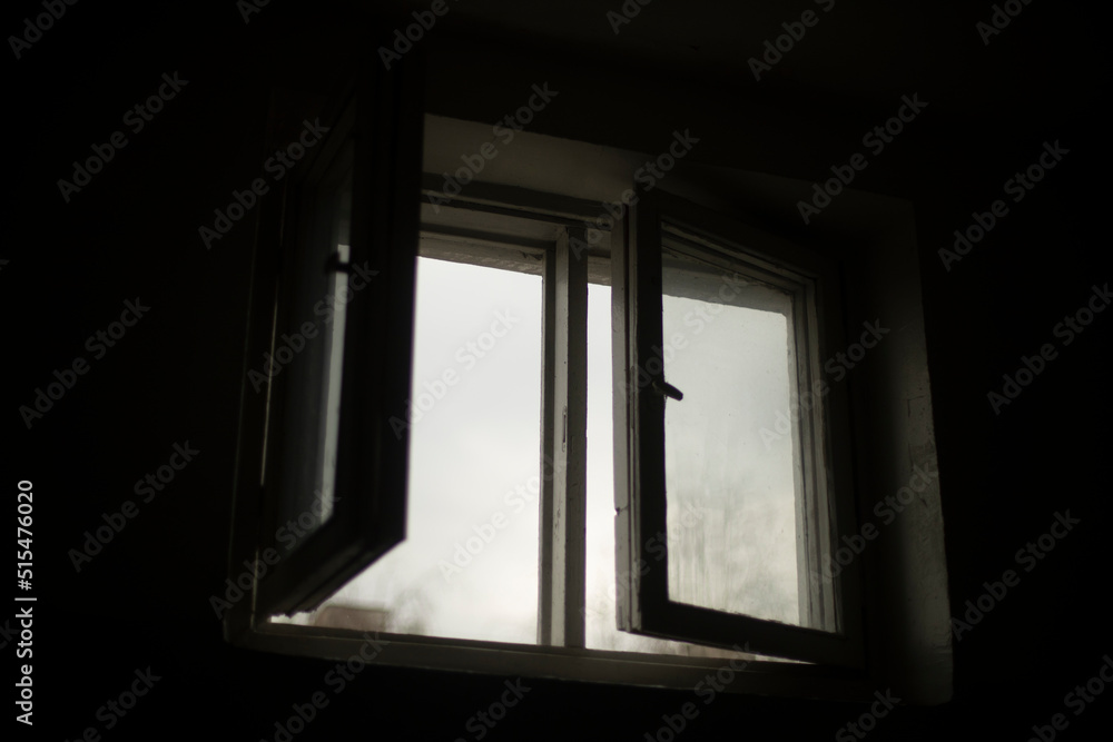 Window is in dark. Open window in building. Window is in dark. Open window in building.