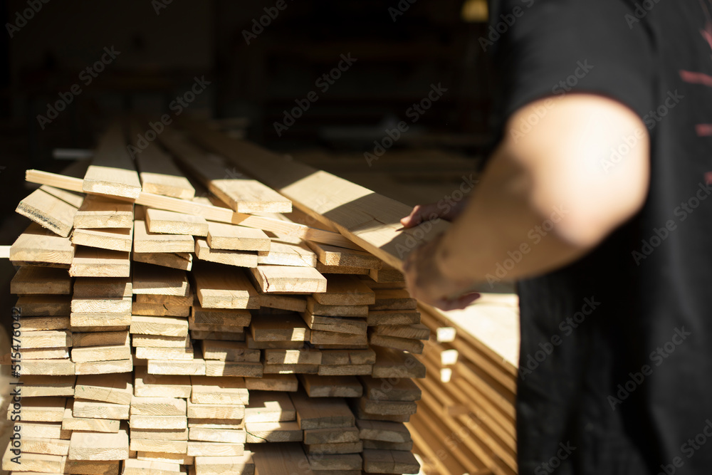 Guy puts boards down. Boards in stock. Guy puts boards down. Boards in stock.