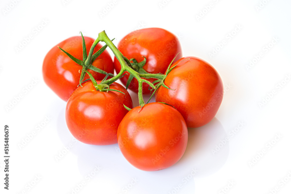 Bunch of ripe fresh tomatoes on a white background Bunch of ripe fresh tomatoes on a white background