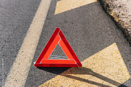 Emergency reflective triangle for broken down cars. Safety signaling system for traffic accidents. © Jorge