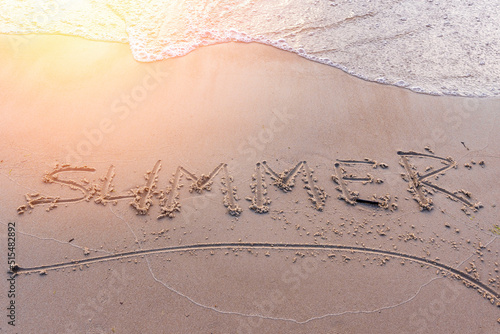 word Summer on the sand on the sea sandy beach in the sunset light