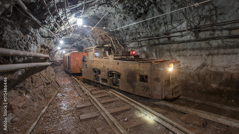 Naklejka premium Old rusty train in iron ore mine.
