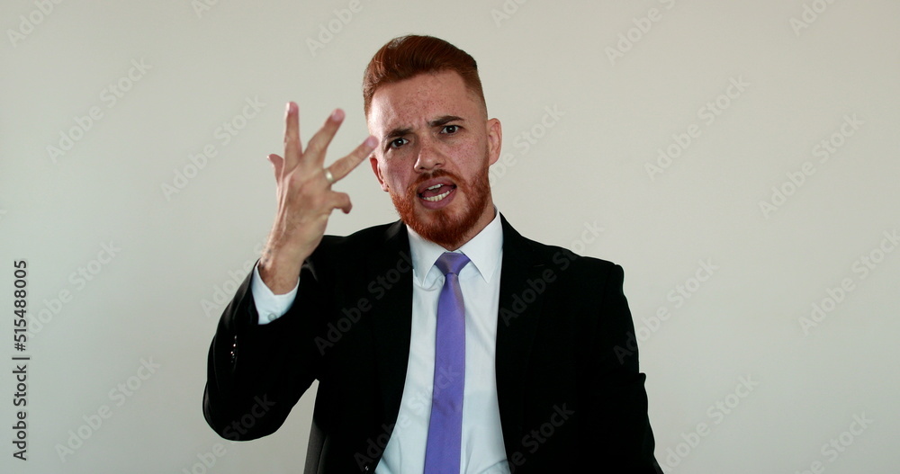 Upset man arguing to camera. Angry business man talking to camera gesturing with hands Upset man arguing to camera. Angry business man talking to camera gesturing with hands