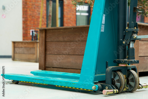 Blue pallet truck to lift goods with a forklift