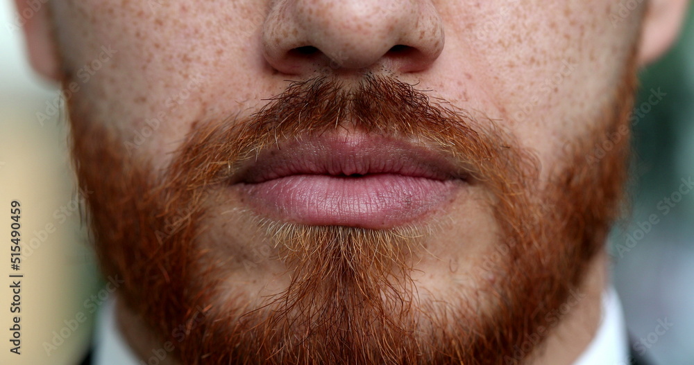 Obraz premium Serious redhead man lips and mouth close-up with red beard