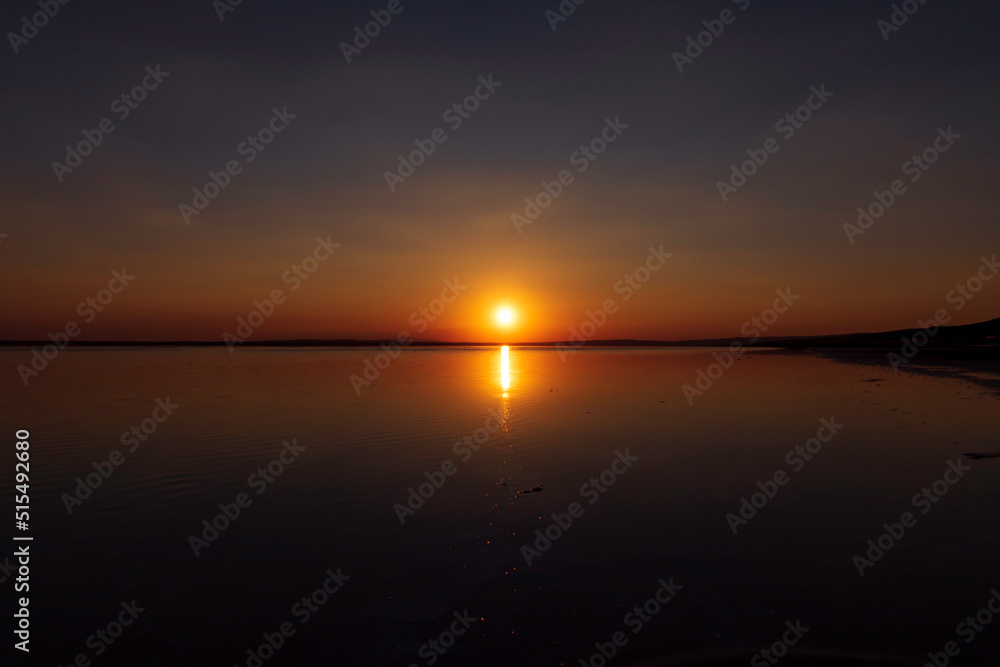 Naklejka premium Sunset or sunrise over the lake. Sundown on the horizon. Nature background photo