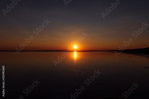 Sunset or sunrise over the lake. Sundown on the horizon. Nature background photo © senerdagasan