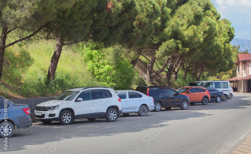 Cars in the parking lot along the street © Yuri Bizgaimer