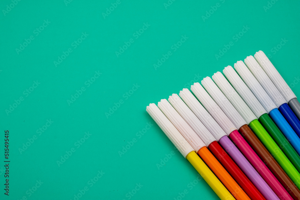 Various colored felt-tip pens on a green table. Back to school. Various colored felt-tip pens on a green table. Back to school.