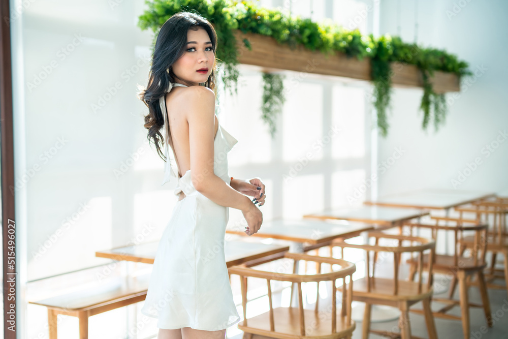 Portrait beautiful asian freelance Success people business woman fashion model in summer white sleeveless dress and coffee in cup in coffee shop. Portrait beautiful asian freelance Success people business woman fashion model in summer white sleeveless dress and coffee in cup in coffee shop.