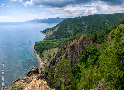 Summer view above from cliff to lake Baikal on sunny day. Beautiful panoramic landscape with clouds photo