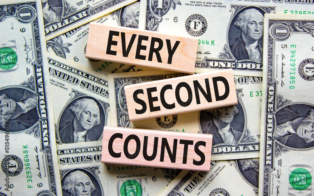 Every second counts symbol. Concept words Every second counts on wooden blocks on a beautiful background from dollar bills. Business, motivational and every second counts concept. Copy space.