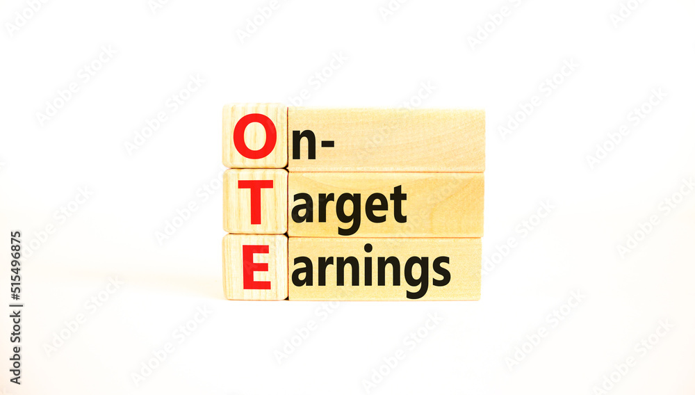 OTE on-target earnings symbol. Concept words OTE on-target earnings on wooden blocks on a beautiful white background. Business and OTE on-target earnings concept. Copy space. OTE on-target earnings symbol. Concept words OTE on-target earnings on wooden blocks on a beautiful white background. Business and OTE on-target earnings concept. Copy space.