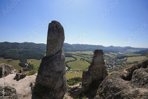 Sulovsky hrad, Sulov Casttle, Slovakia - ruins and remains of old historical building on the top of rock. Landscape with mountains and hills. Wide angle distortion with soft corners. photo