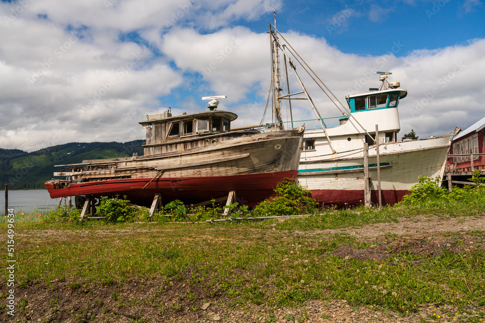 Two small abandoned fishing boats on the waterside at Icy strait Point near Hoonah Two small abandoned fishing boats on the waterside at Icy strait Point near Hoonah