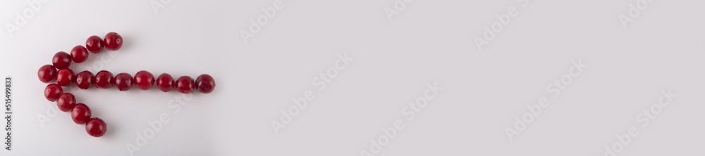 red arrow made of fresh cherry fruits on white background red arrow made of fresh cherry fruits on white background