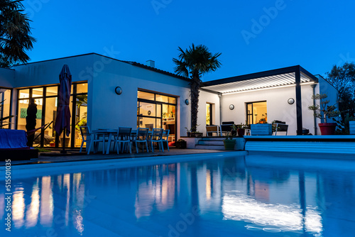 Tableau sur toile night shot of a modern house with pergola bioclimatic