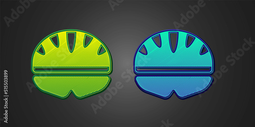 Green and blue Bicycle helmet icon isolated on black background. Extreme sport. Sport equipment. Vector