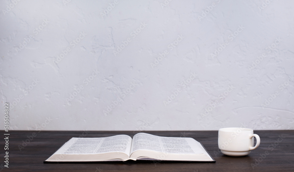 Open Holy Bible, on the table. Prayer. A cup of coffee Open Holy Bible, on the table. Prayer. A cup of coffee