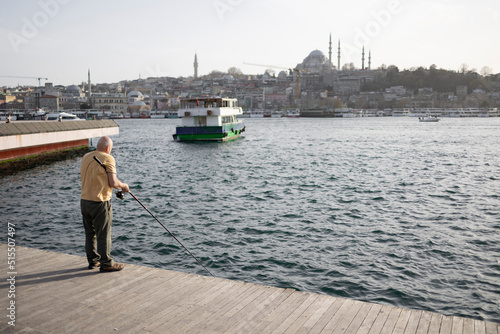 Back view of old fisherman. İstanbul city view.