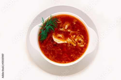 Traditional Russian cabbage soup in a ceramic bowl on a white insulated background. Flat lay.
