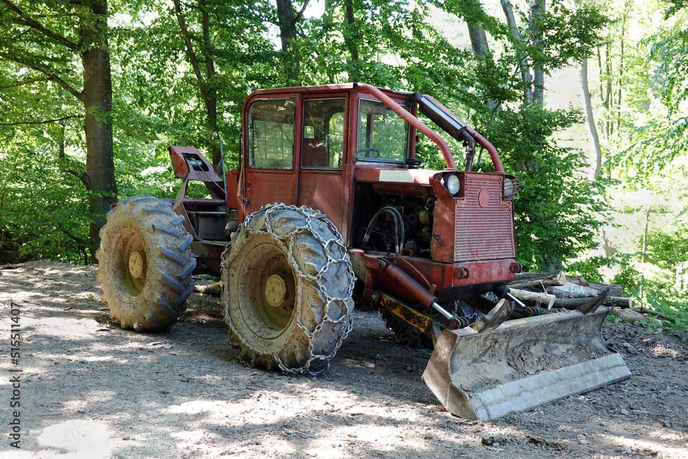 Logging tractor for harvesting felled trees in the forest Logging tractor for harvesting felled trees in the forest
