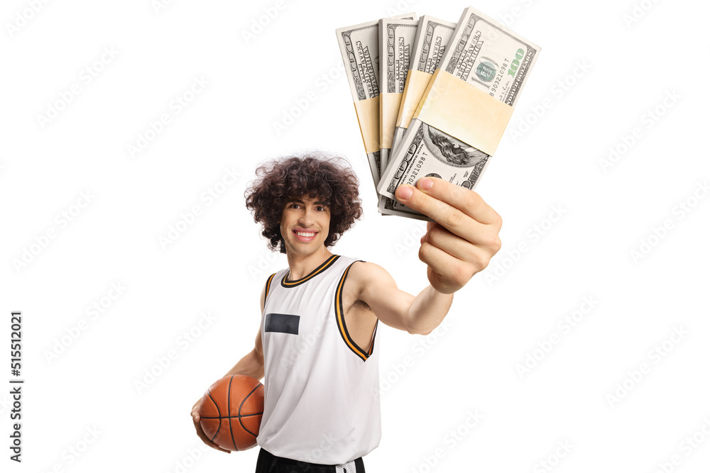 Basketball player holding a ball and money banknotes Basketball player holding a ball and money banknotes